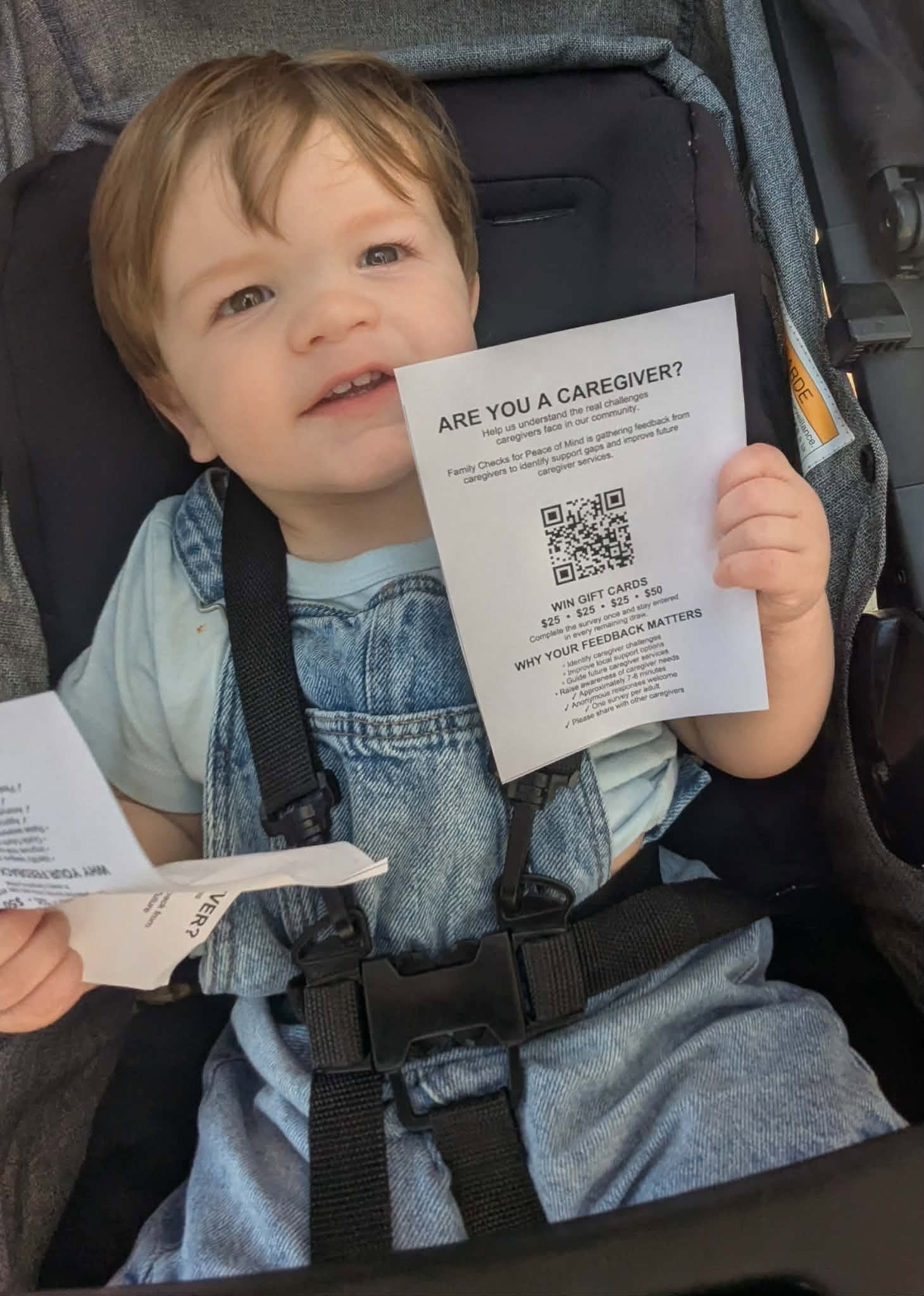 Joel holding Family Checks caregiver questionnaire flyers.